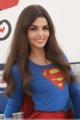 A woman in a superman costume posing for a picture.