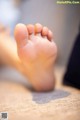 A close up of a person's foot on a rug.