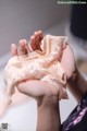 A woman holding a piece of lingerie in her hands.