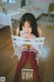 A woman sitting on top of a white chair.