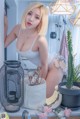 A woman in a white lingerie posing next to a cactus.